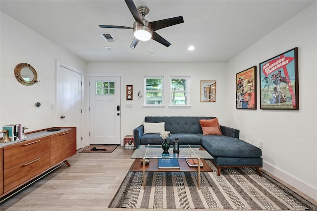 living room with light hardwood / wood-style floors and ceiling fan