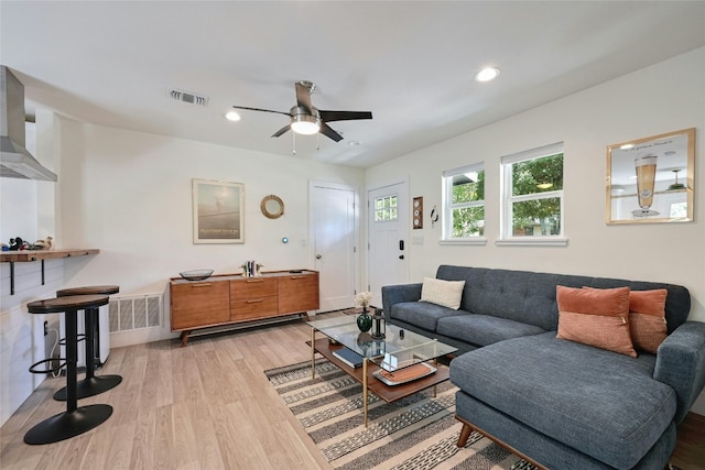 living room featuring ceiling fan and light hardwood / wood-style flooring