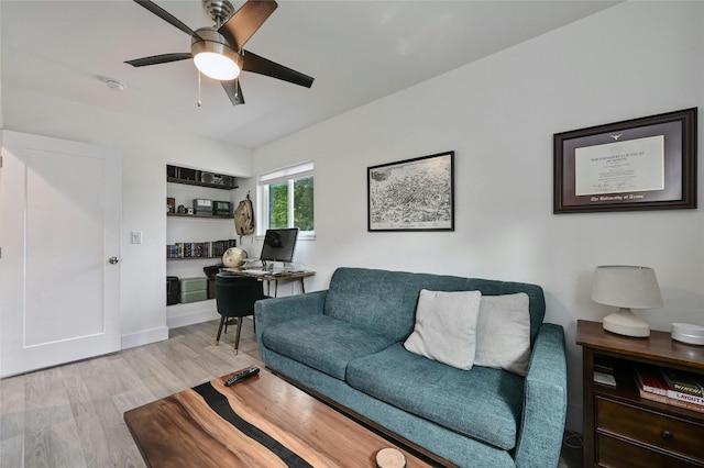 living room with ceiling fan and light hardwood / wood-style flooring