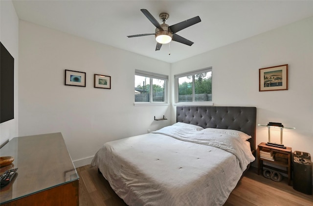 bedroom with ceiling fan and wood-type flooring