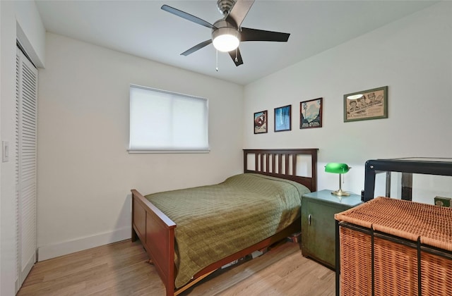 bedroom with ceiling fan, a closet, and light wood-type flooring