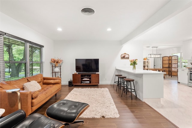 living room featuring hardwood / wood-style flooring and indoor bar