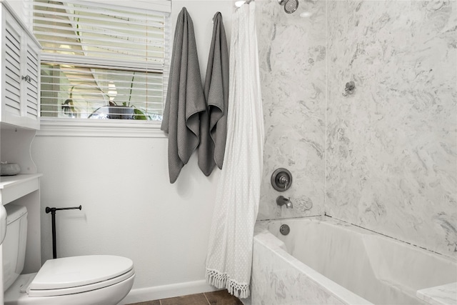 bathroom featuring tile patterned flooring, toilet, and shower / bathtub combination with curtain