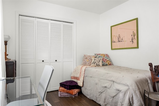 bedroom featuring a closet and dark hardwood / wood-style floors