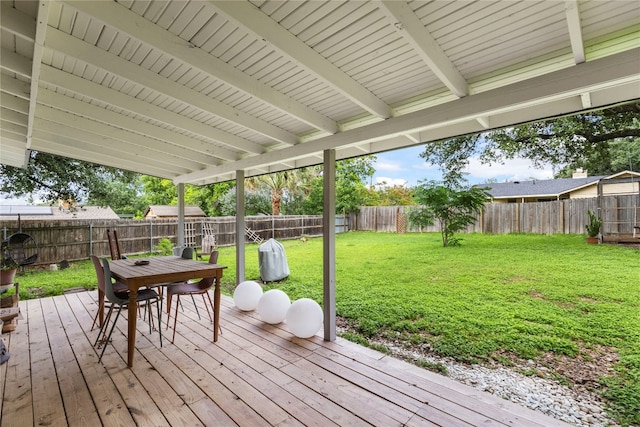 wooden terrace featuring a yard