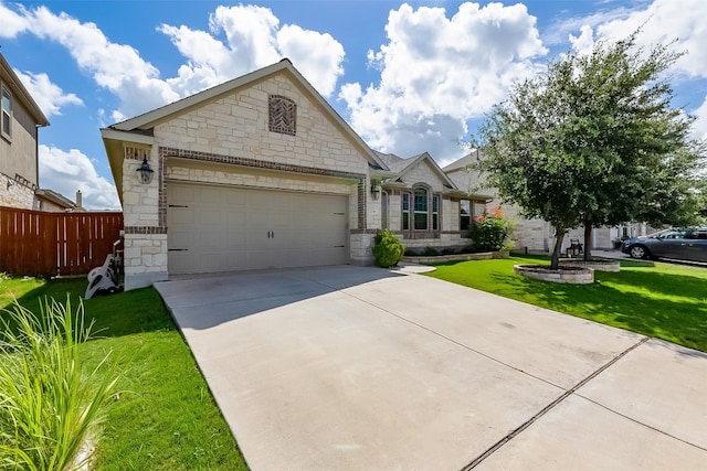 view of front of home featuring a front yard and a garage