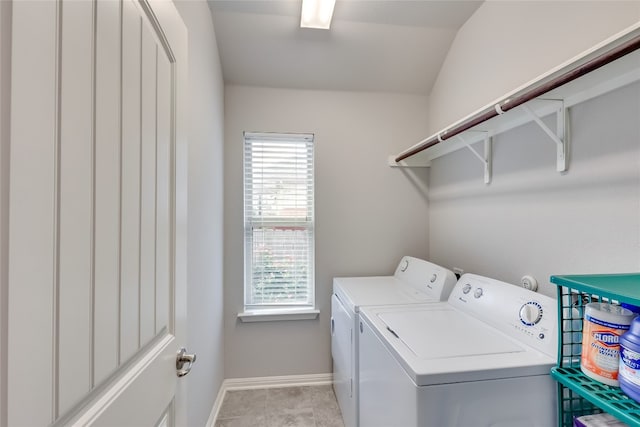 clothes washing area featuring light tile patterned flooring and independent washer and dryer