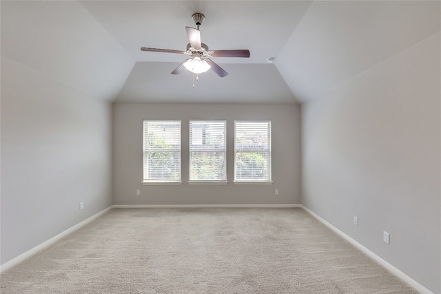 carpeted spare room with ceiling fan and lofted ceiling