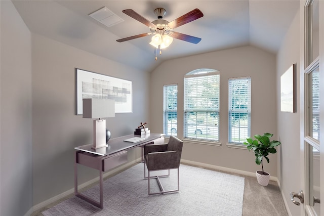 office area with light carpet, ceiling fan, a healthy amount of sunlight, and lofted ceiling