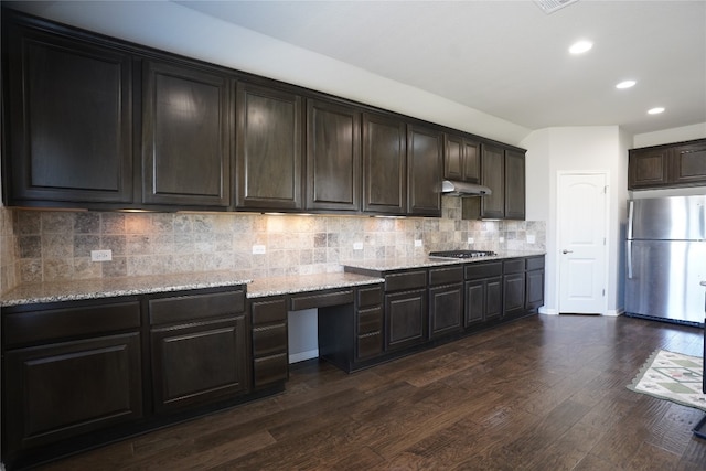 kitchen featuring decorative backsplash, light stone counters, dark brown cabinets, stainless steel appliances, and dark hardwood / wood-style floors