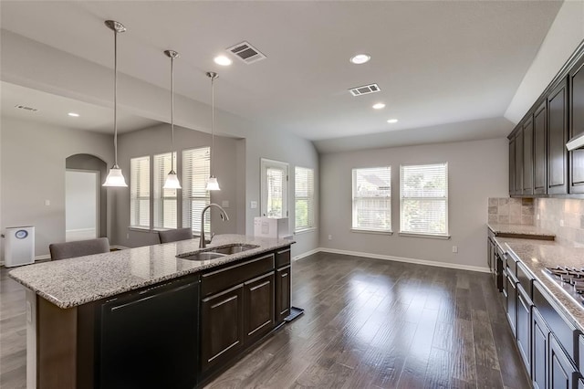 kitchen featuring dishwasher, a center island with sink, sink, dark brown cabinets, and dark hardwood / wood-style flooring