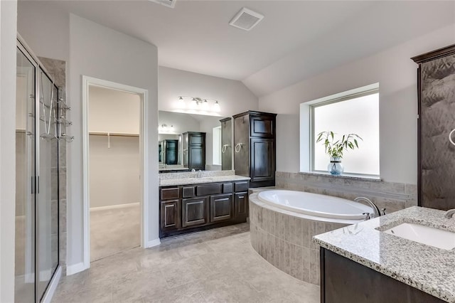 bathroom with shower with separate bathtub, vanity, tile patterned floors, and lofted ceiling