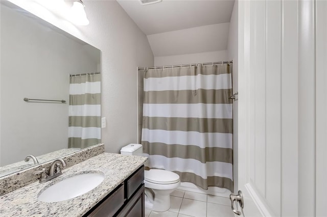 bathroom with toilet, vanity, tile patterned floors, and curtained shower