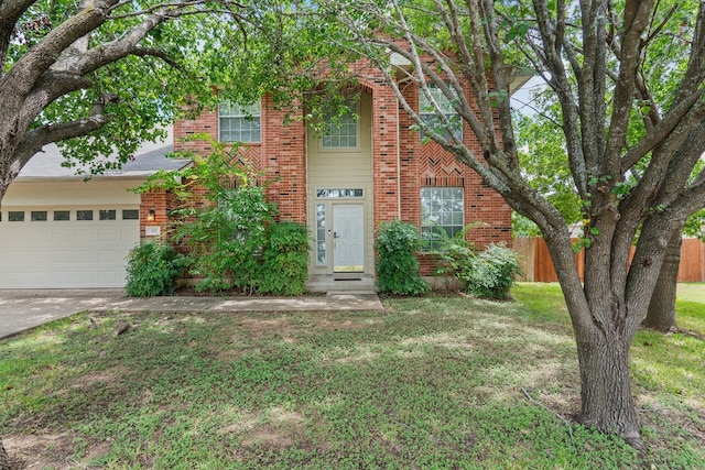 view of front of property with a front lawn and a garage