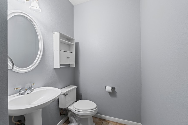 bathroom featuring toilet and sink