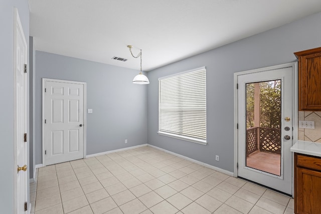 unfurnished dining area featuring light tile patterned floors