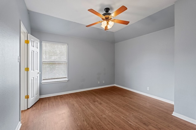 empty room with ceiling fan and hardwood / wood-style flooring