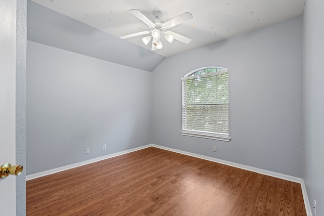 empty room featuring wood-type flooring, ceiling fan, and lofted ceiling