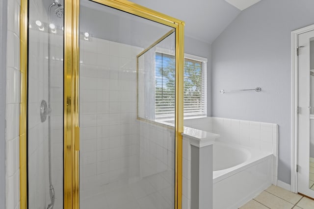 bathroom featuring independent shower and bath, tile patterned floors, and lofted ceiling