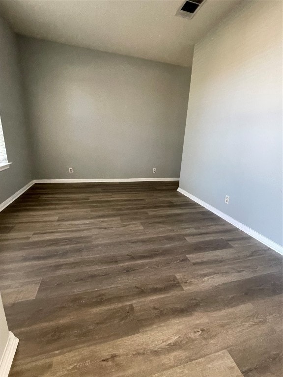 empty room featuring dark wood-type flooring