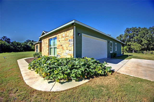 view of home's exterior with a yard and a garage