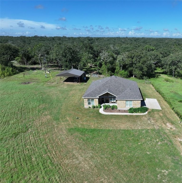 birds eye view of property with a forest view