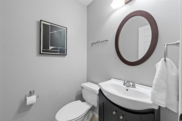 bathroom featuring toilet and vanity