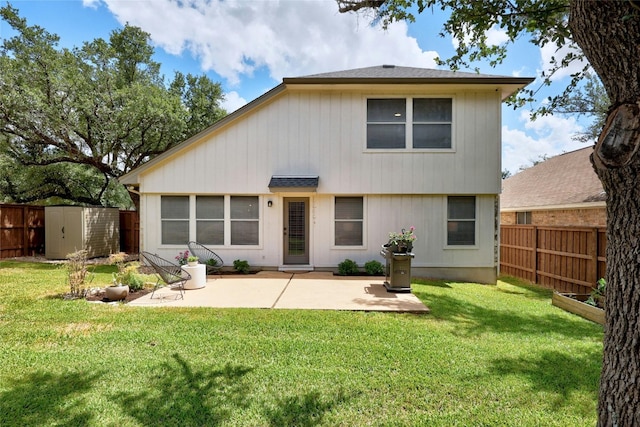 back of property featuring a lawn, a shed, and a patio