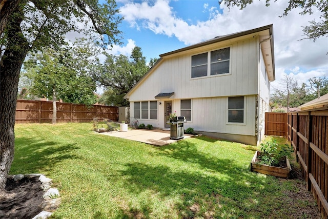 rear view of property featuring a patio area and a yard