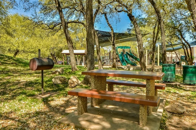 view of property's community with a playground