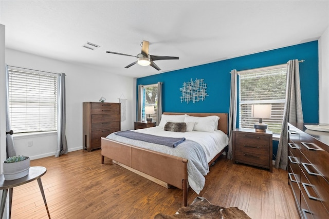 bedroom featuring ceiling fan and dark hardwood / wood-style floors