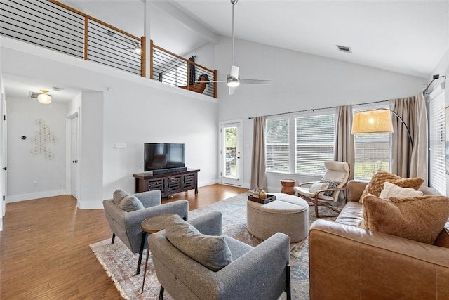 living room with ceiling fan, beamed ceiling, high vaulted ceiling, and hardwood / wood-style flooring