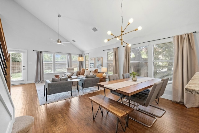 dining room featuring high vaulted ceiling, ceiling fan with notable chandelier, and hardwood / wood-style flooring