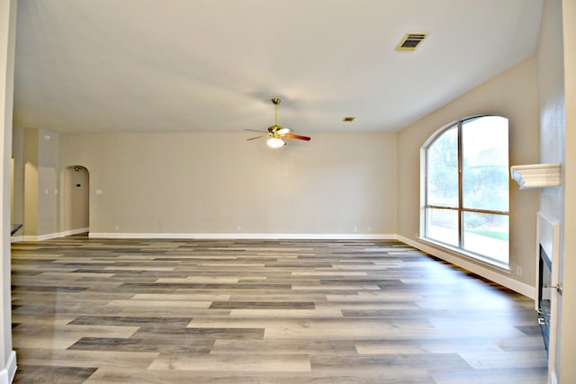 unfurnished living room featuring ceiling fan and light hardwood / wood-style flooring