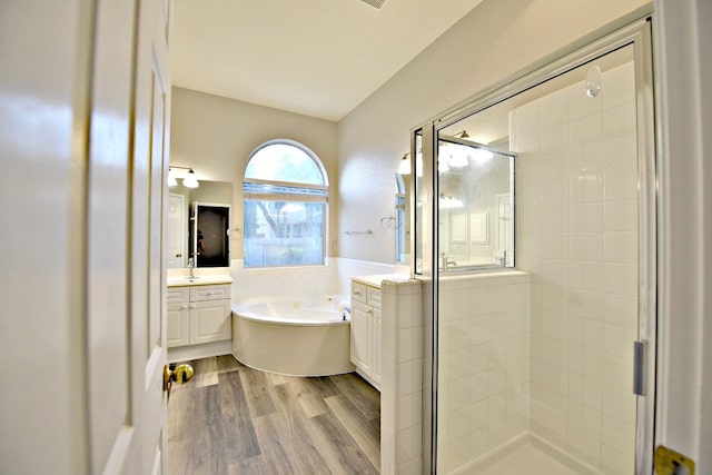 bathroom featuring vanity, hardwood / wood-style floors, and independent shower and bath