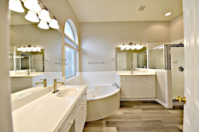 bathroom featuring vanity, wood-type flooring, and independent shower and bath