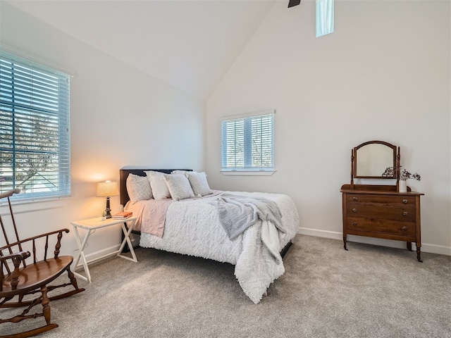 carpeted bedroom featuring high vaulted ceiling