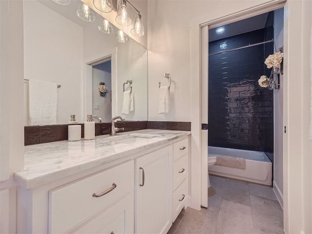 full bathroom featuring tile patterned flooring, vanity, toilet, and tiled shower / bath combo