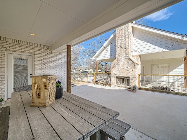 view of patio / terrace featuring an outdoor stone fireplace