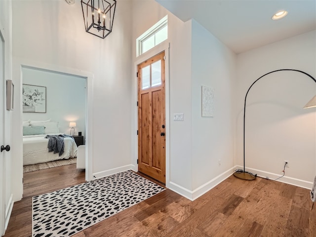 foyer featuring a chandelier and dark wood-type flooring