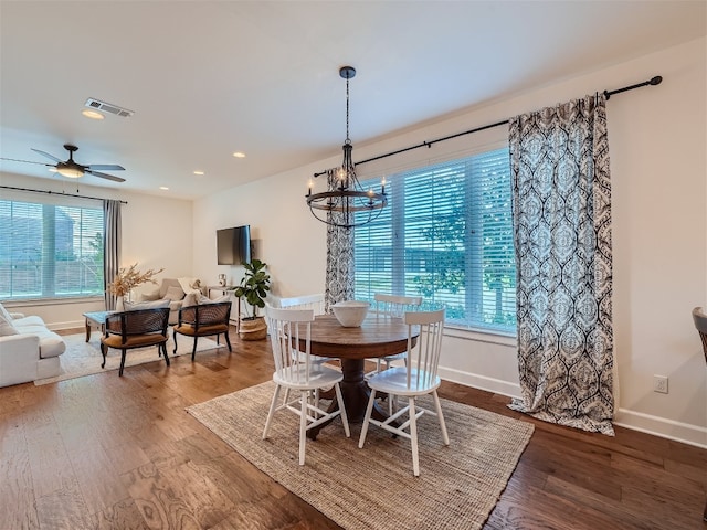 dining room featuring hardwood / wood-style floors, ceiling fan with notable chandelier, and plenty of natural light