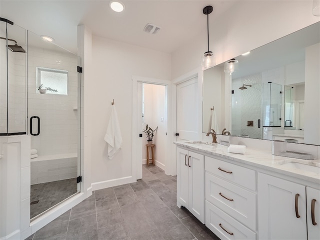 bathroom featuring tile patterned flooring, vanity, and an enclosed shower