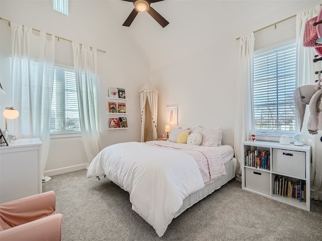 bedroom featuring light colored carpet, vaulted ceiling, and ceiling fan