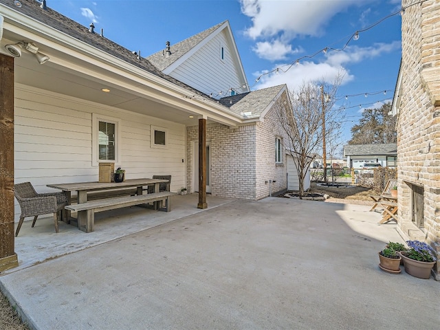 view of patio with an outdoor fireplace