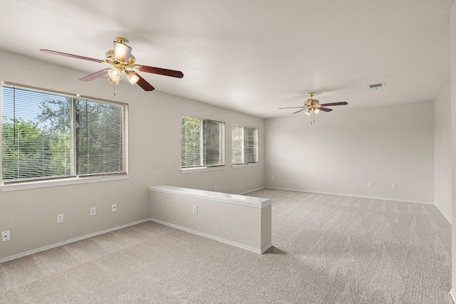 carpeted empty room featuring ceiling fan