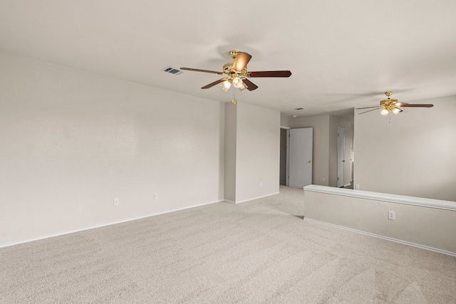 spare room with light colored carpet and ceiling fan