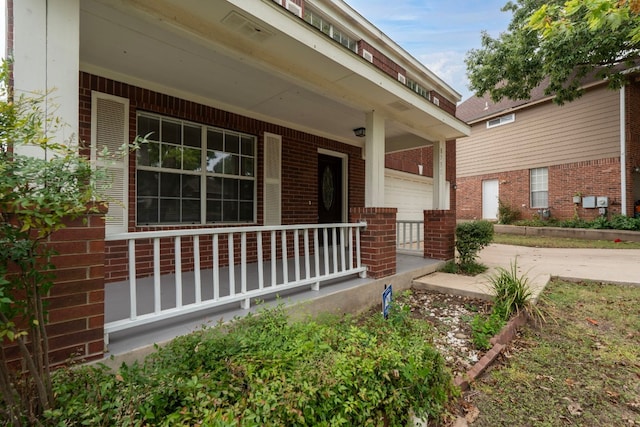 view of exterior entry featuring a porch