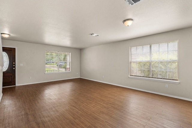 unfurnished room featuring a textured ceiling and hardwood / wood-style flooring