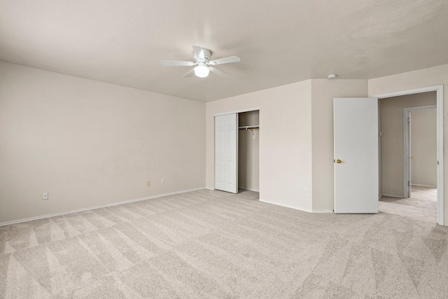 unfurnished bedroom featuring a closet, ceiling fan, and light colored carpet