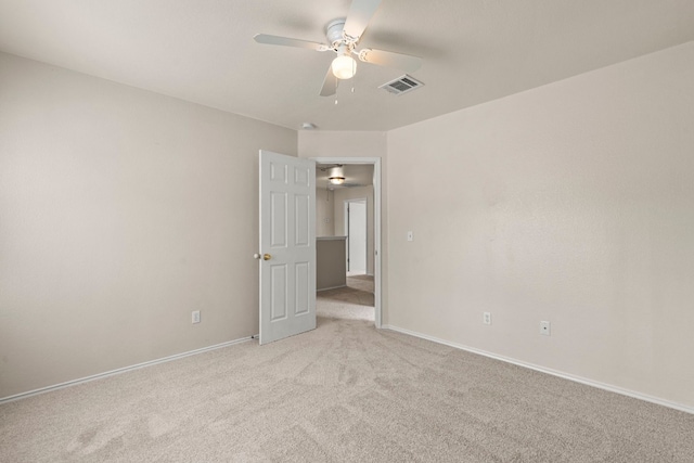 carpeted spare room with ceiling fan